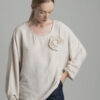 Beige oversize blouse with a decorative flower