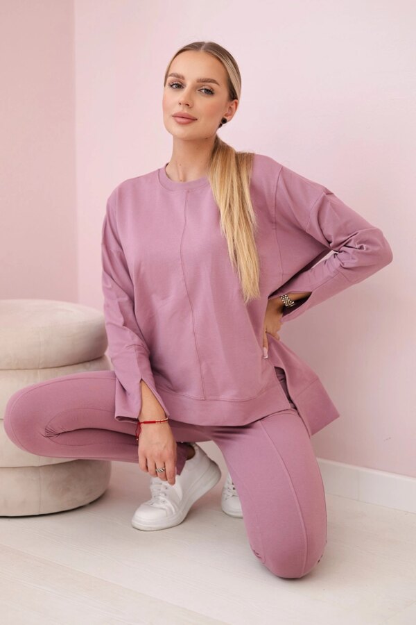 Complete with an oversized blouse in dark pink