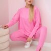 Complete with an oversized blouse in light pink color