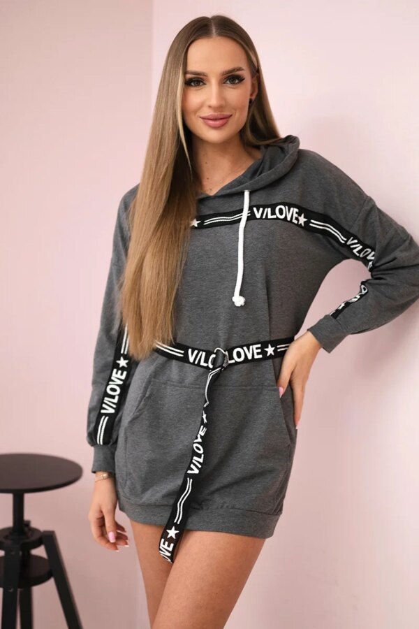 Dress decorated with a graphite slogan tape