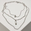 Layered necklace with a silver-colored amulet