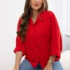 Oversized blouse with red button fastening