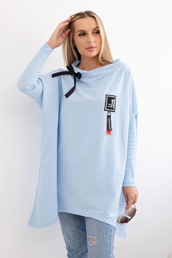 Oversized sweatshirt with asymmetrical sides in cyan color