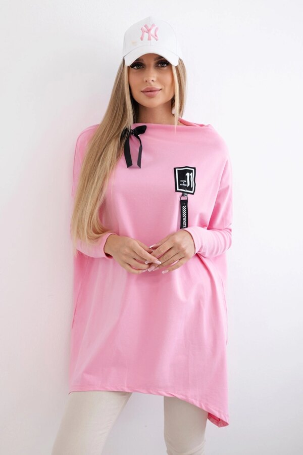 Oversized sweatshirt with asymmetrical sides in light pink color