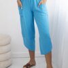 Turquoise trousers with wide legs and pockets