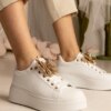UR/CEO White sneakers adorned with a rhinestone butterfly Kariba